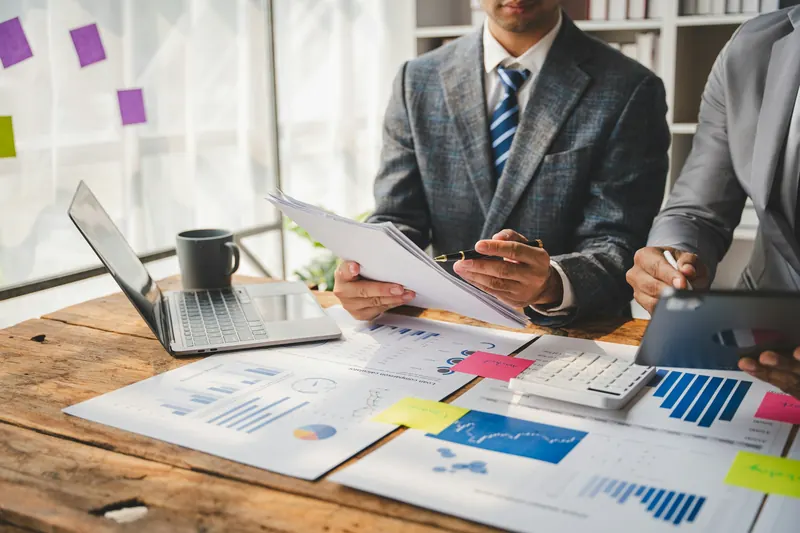 A team reviewing financial charts together at a meeting table