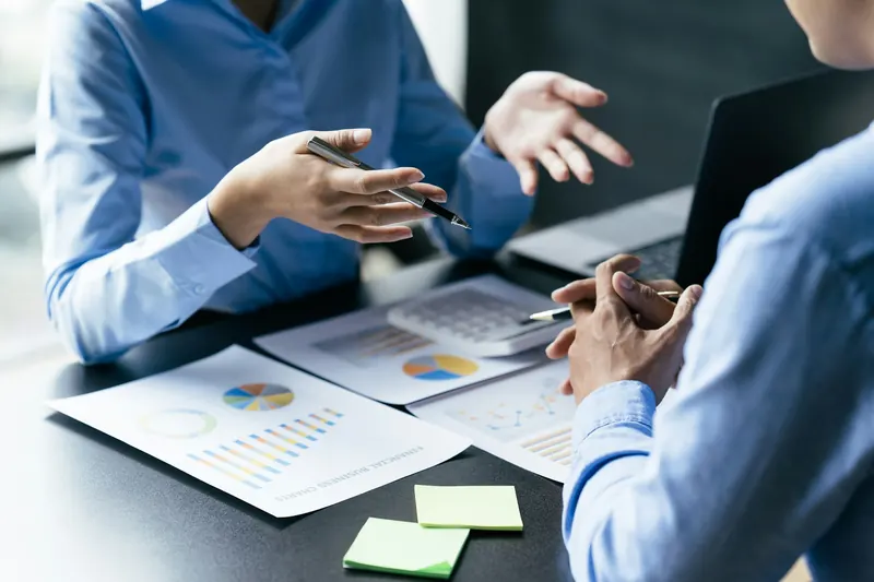 A team reviewing a chart and financial reports